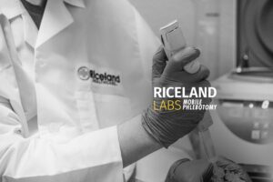 gloved, medical professional holding laboratory equipment, with the text, "RICELAND LABS Mobile Phlebotomy"